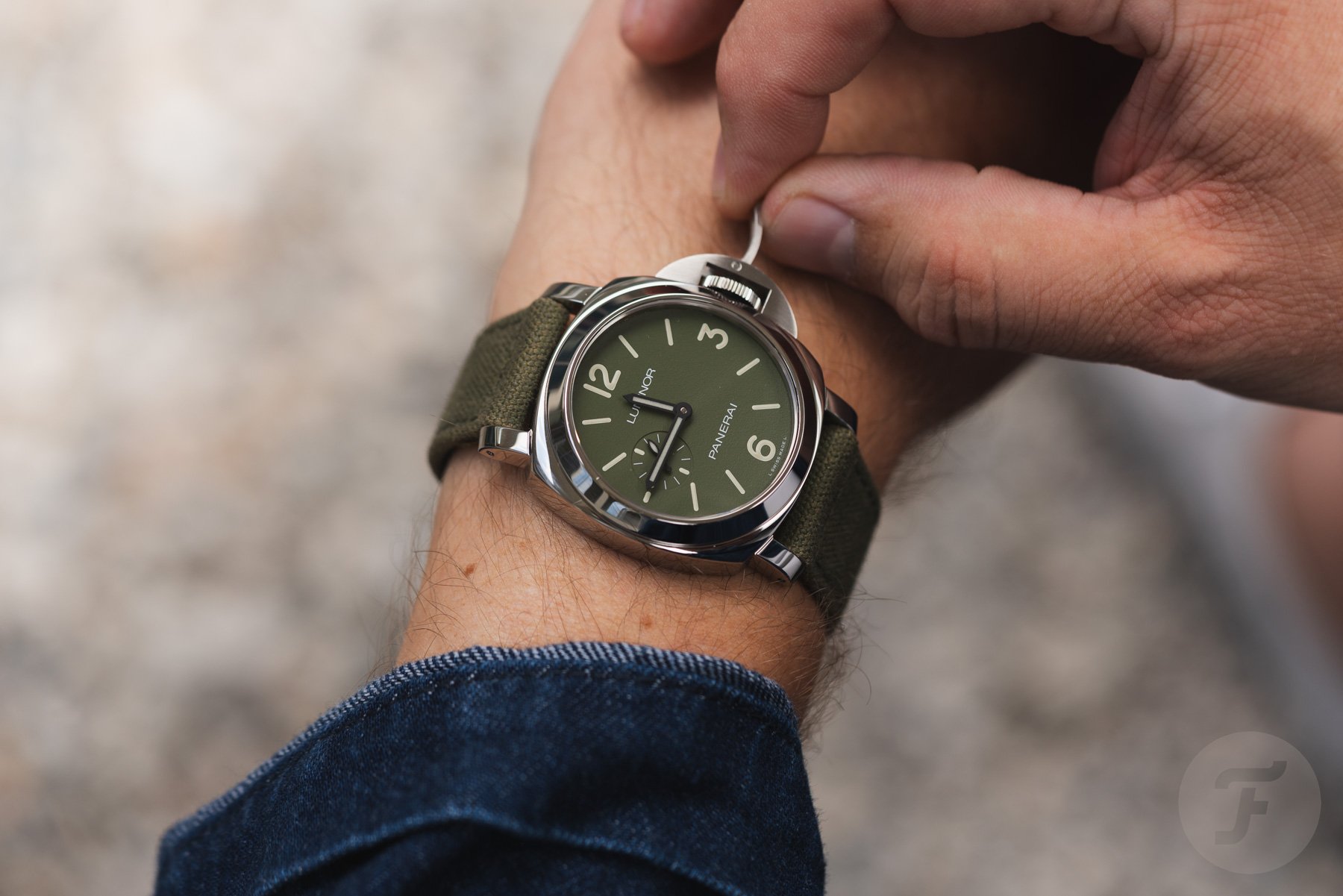 Panerai Luminor PAM01711 on wrist, fingers on crown latch
