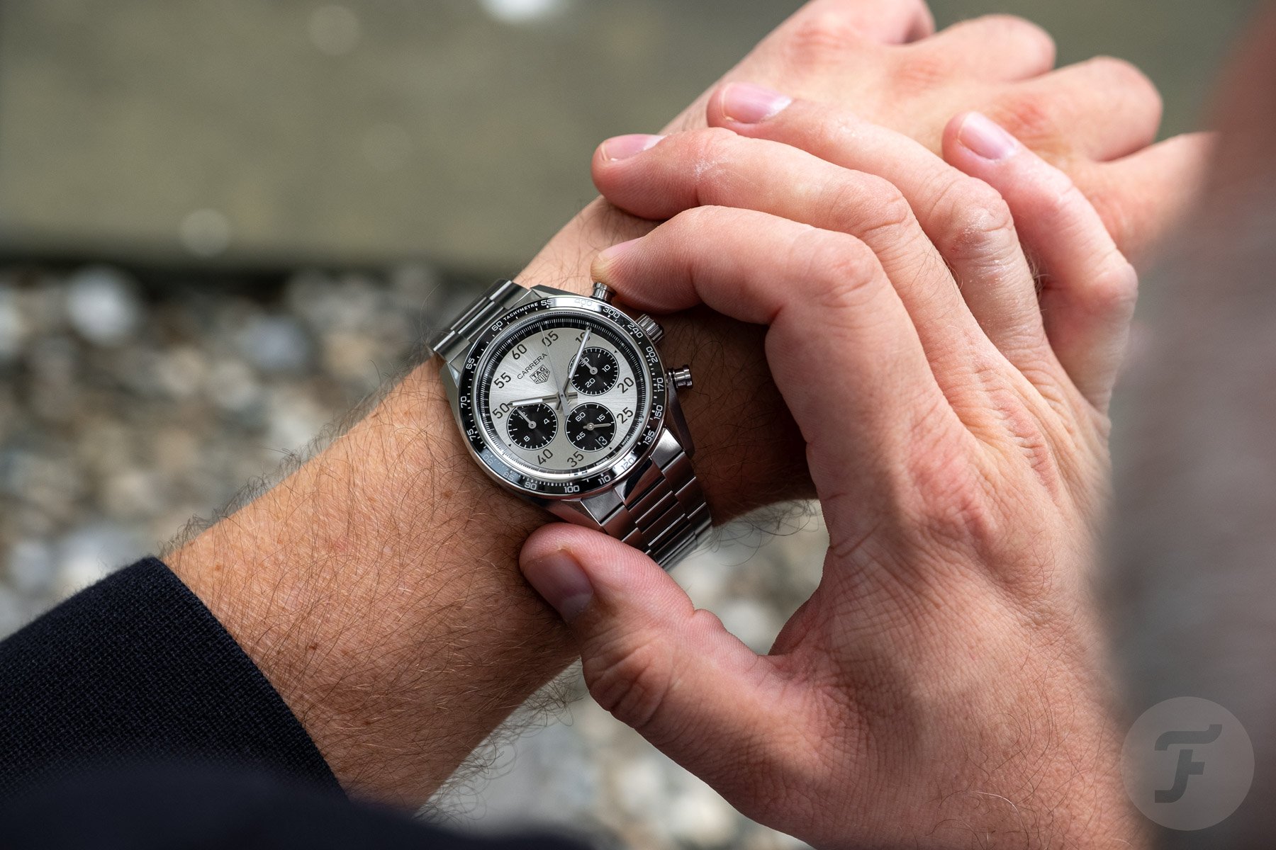 2026 panda-dial TAG Heuer Carrera Chronograph Sport on wrist, finger on top pusher