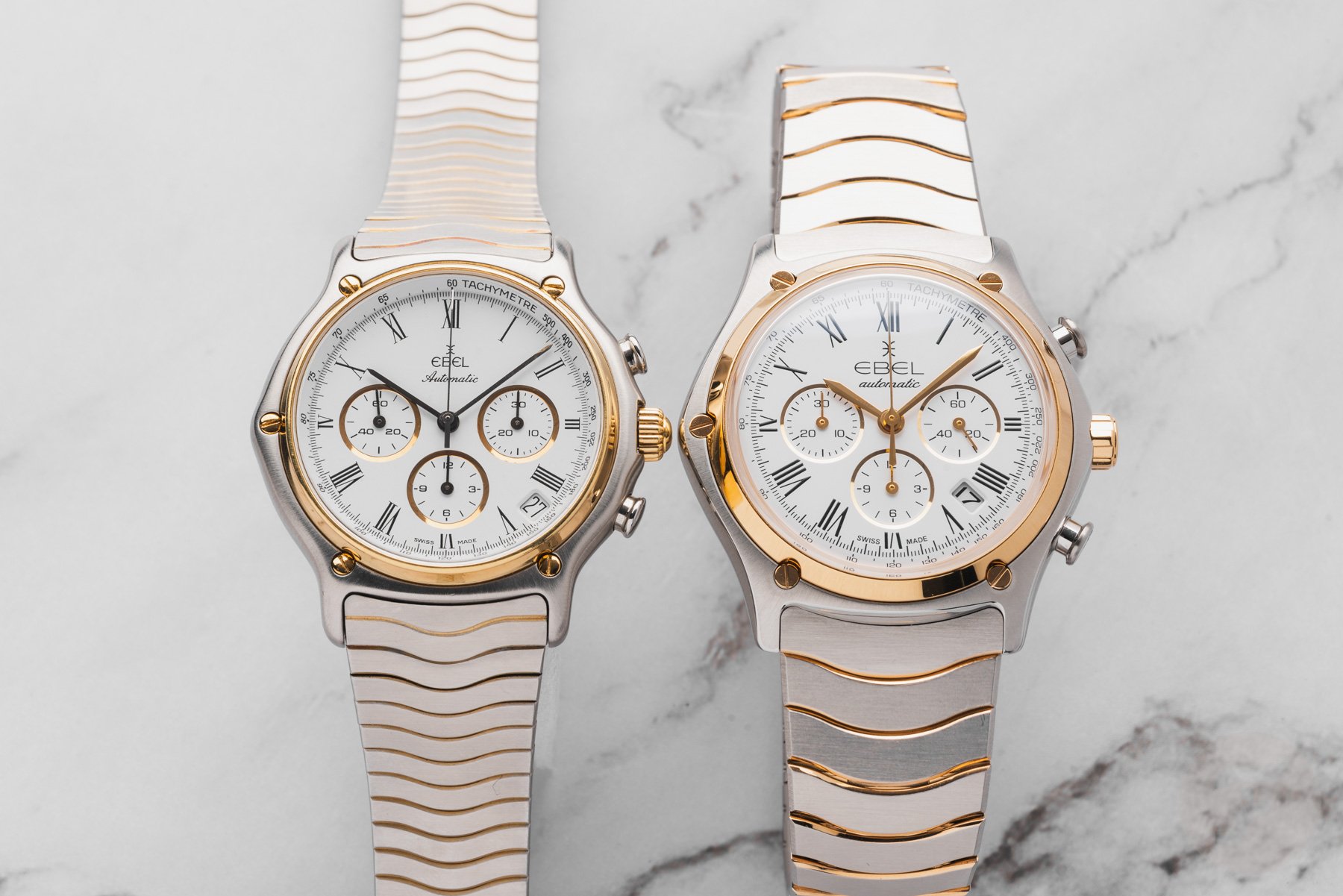 vintage and modern steel-and-gold blue-dial Ebel Sport Classic Chronographs side by side