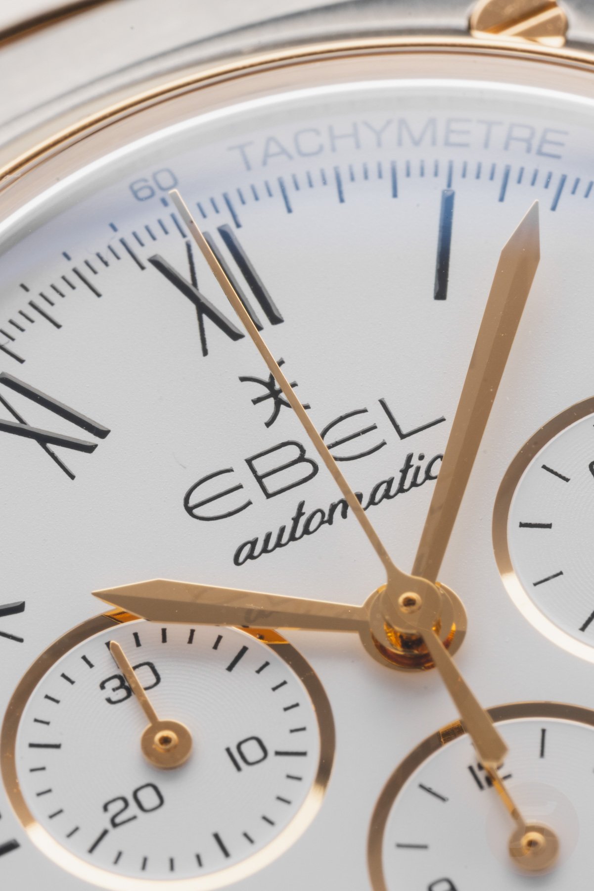 steel-and-gold white-dial Ebel Sport Classic Chronograph LE macro shot