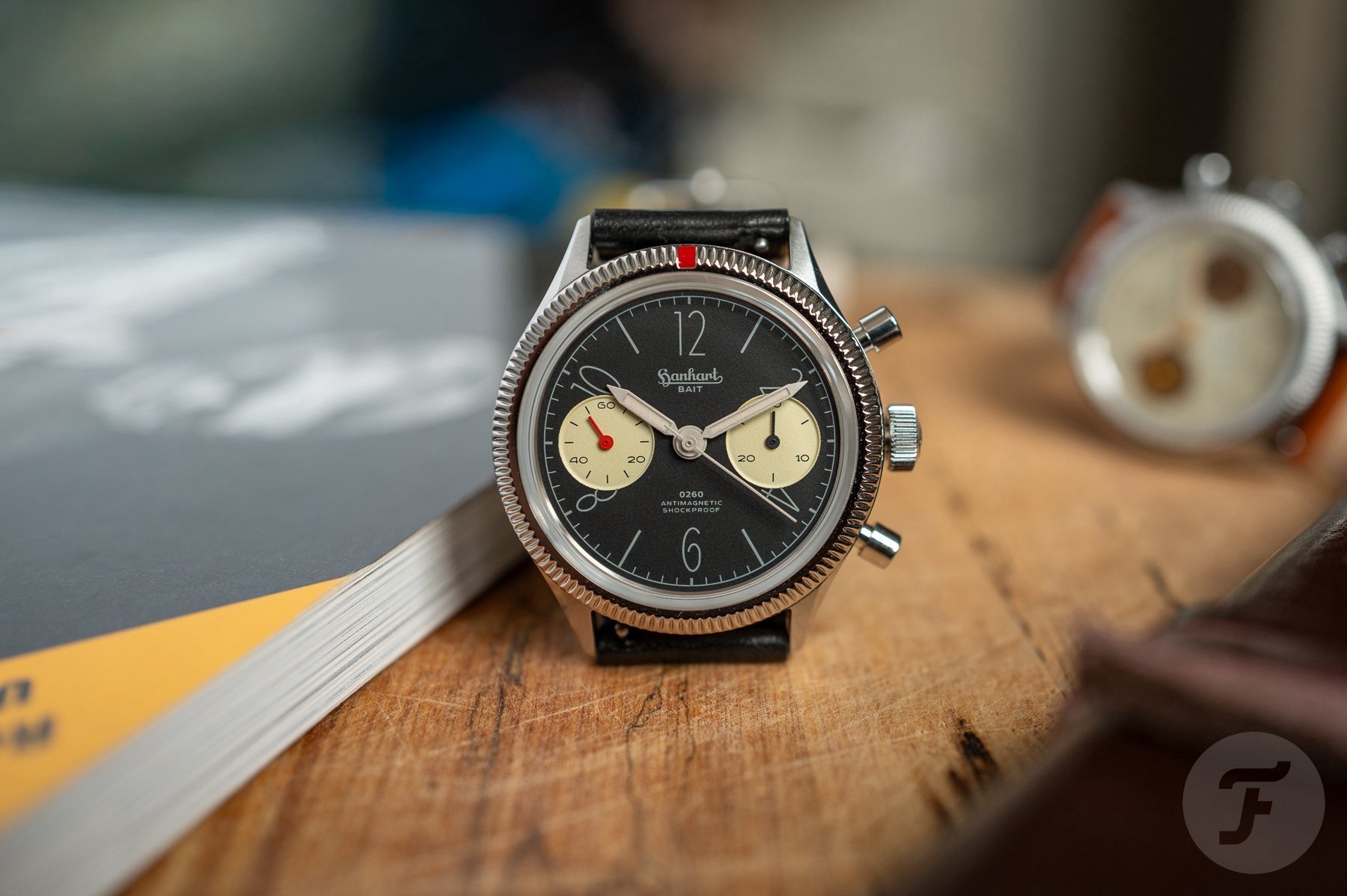 black-dial Hanhart 417 ES × 0260 & BAIT head on, propped up with strap