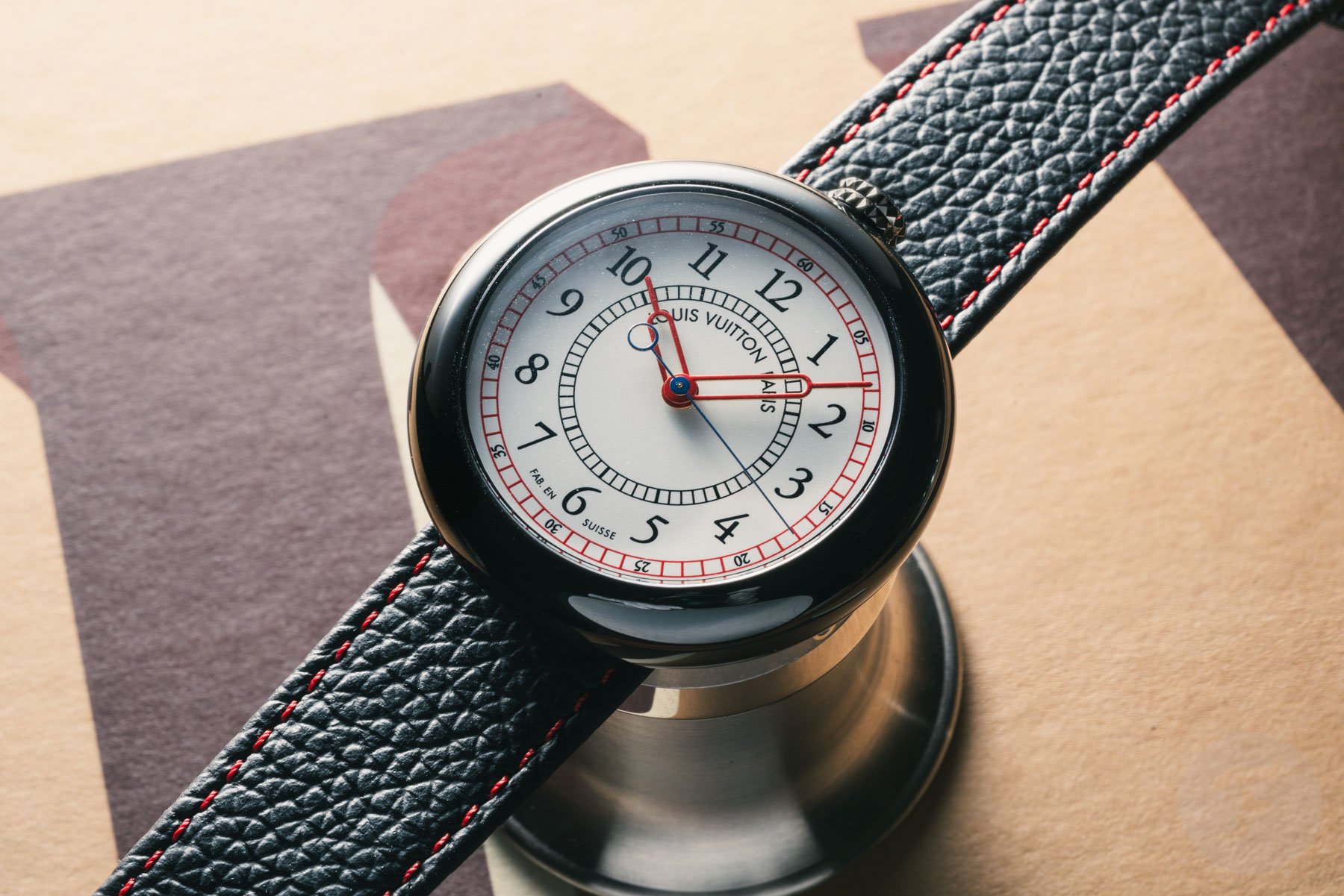 black ceramic Louis Vuitton Monterey on top of loupe