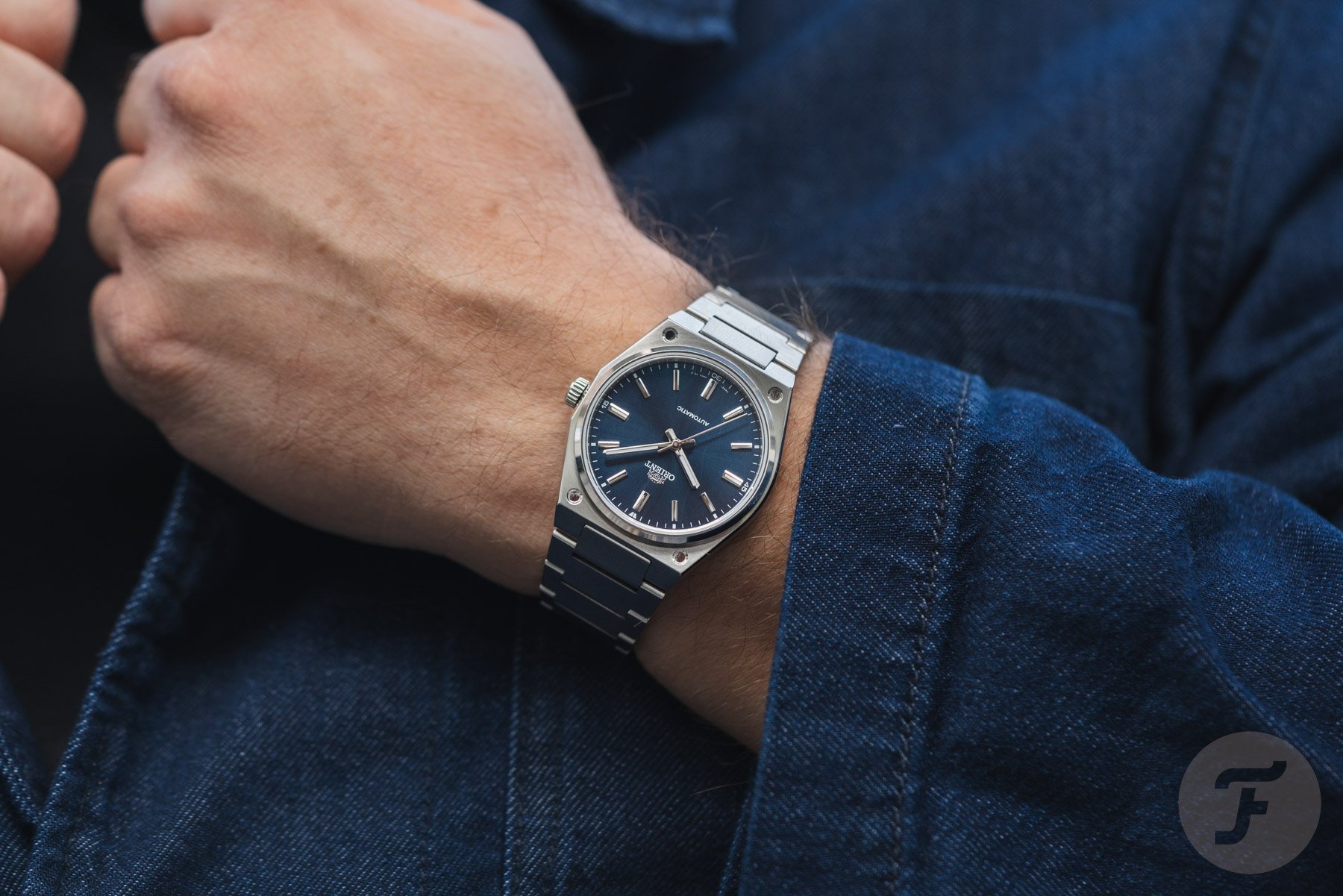 Orient Flusso RA-BB0203L on wrist, hands on lapel
