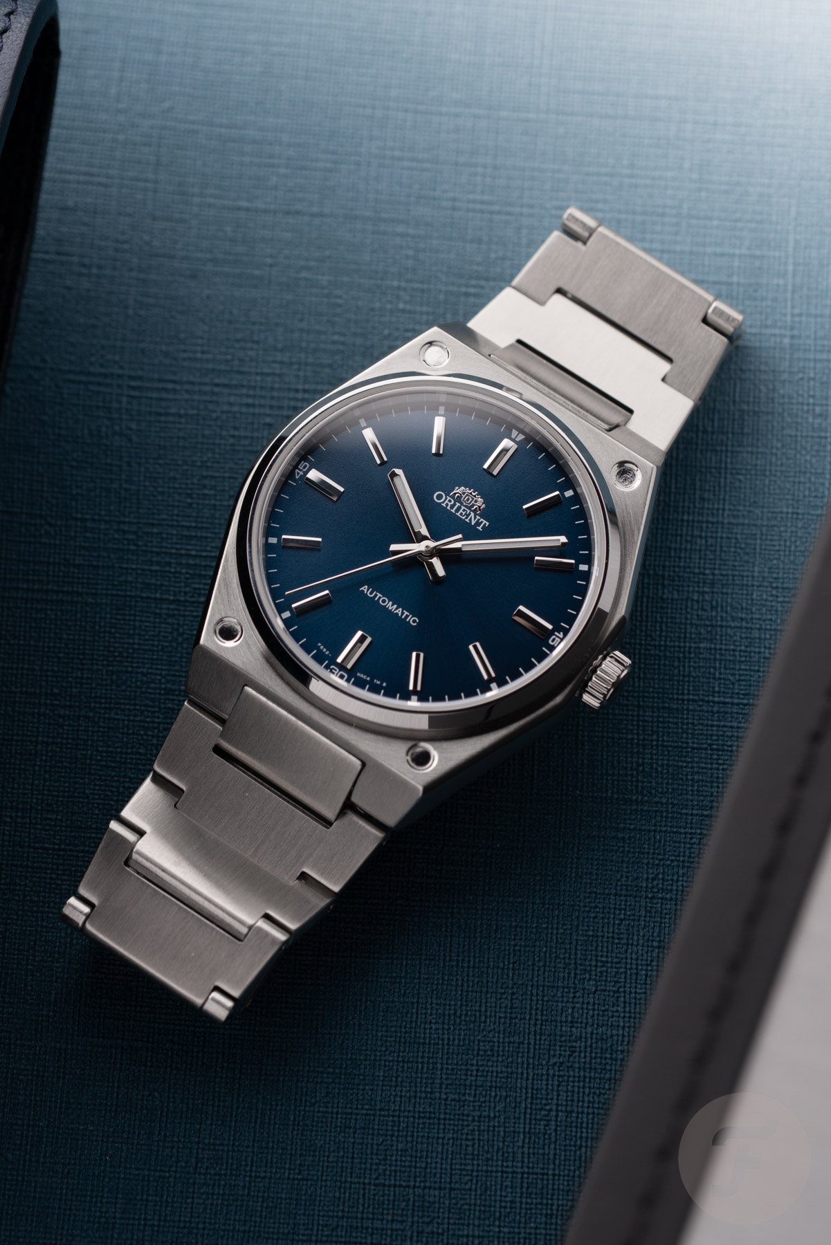 Orient Flusso RA-BB0203L flat-lay on blue surface