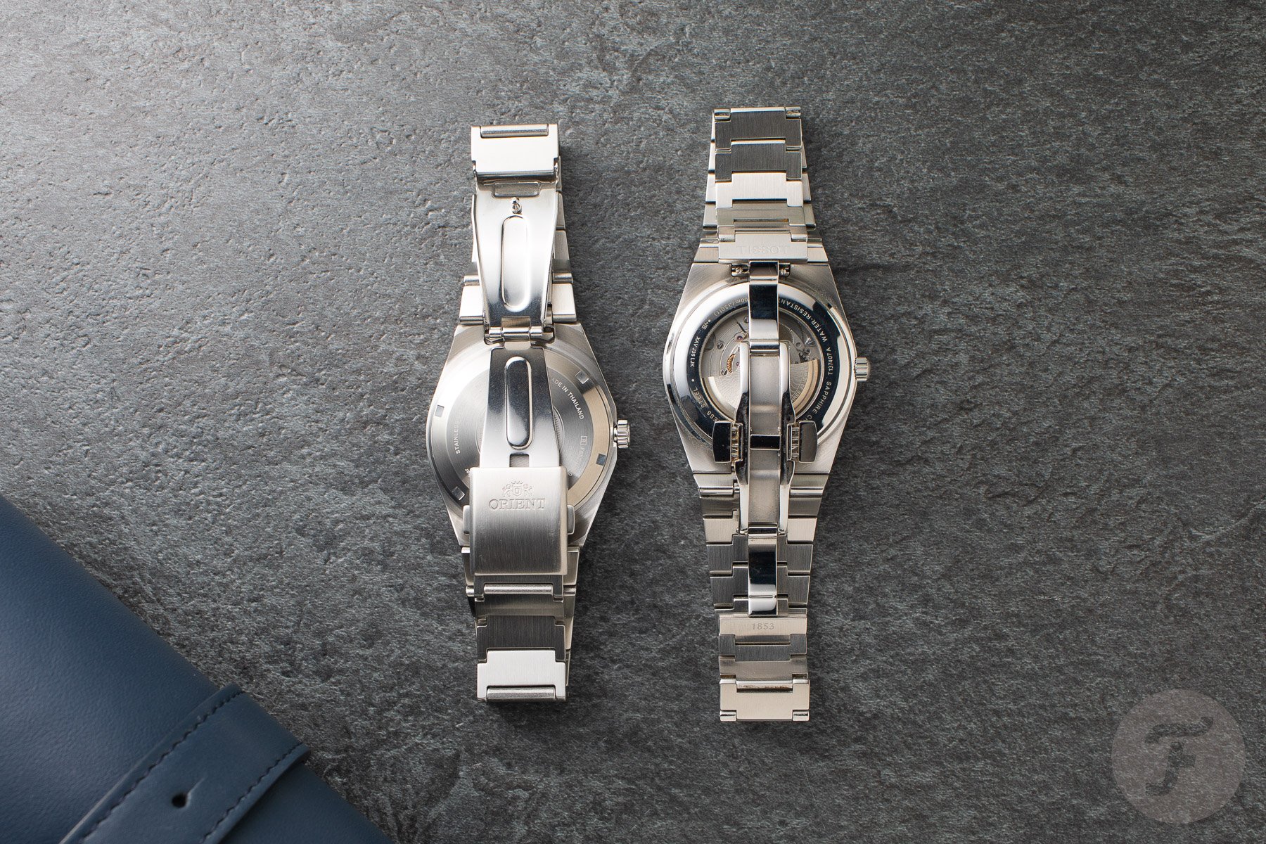 Orient Flusso and Tissot PRX face down, clasps open