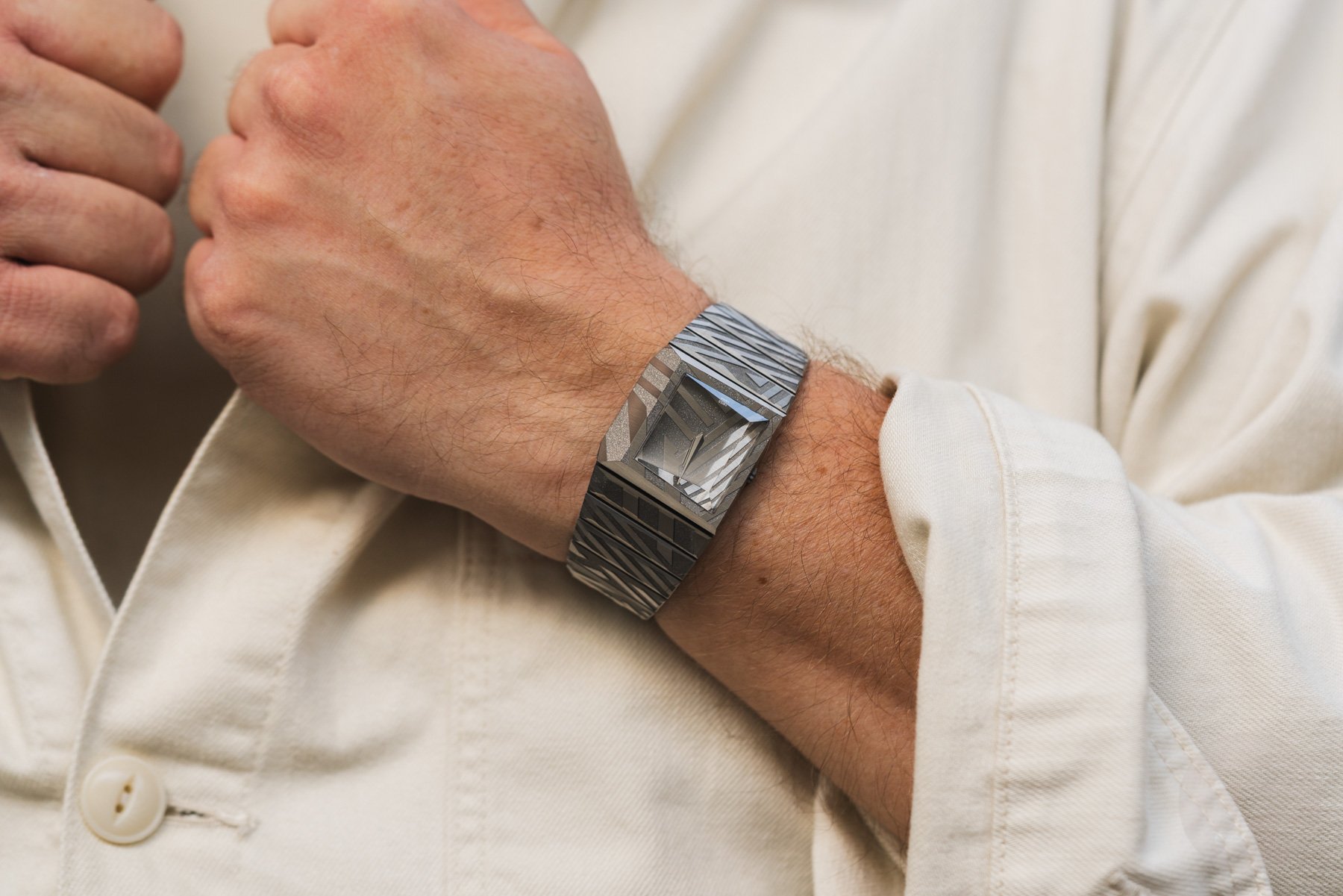 Toledano & Chan B/1 Dazzle on wrist, hands on lapel
