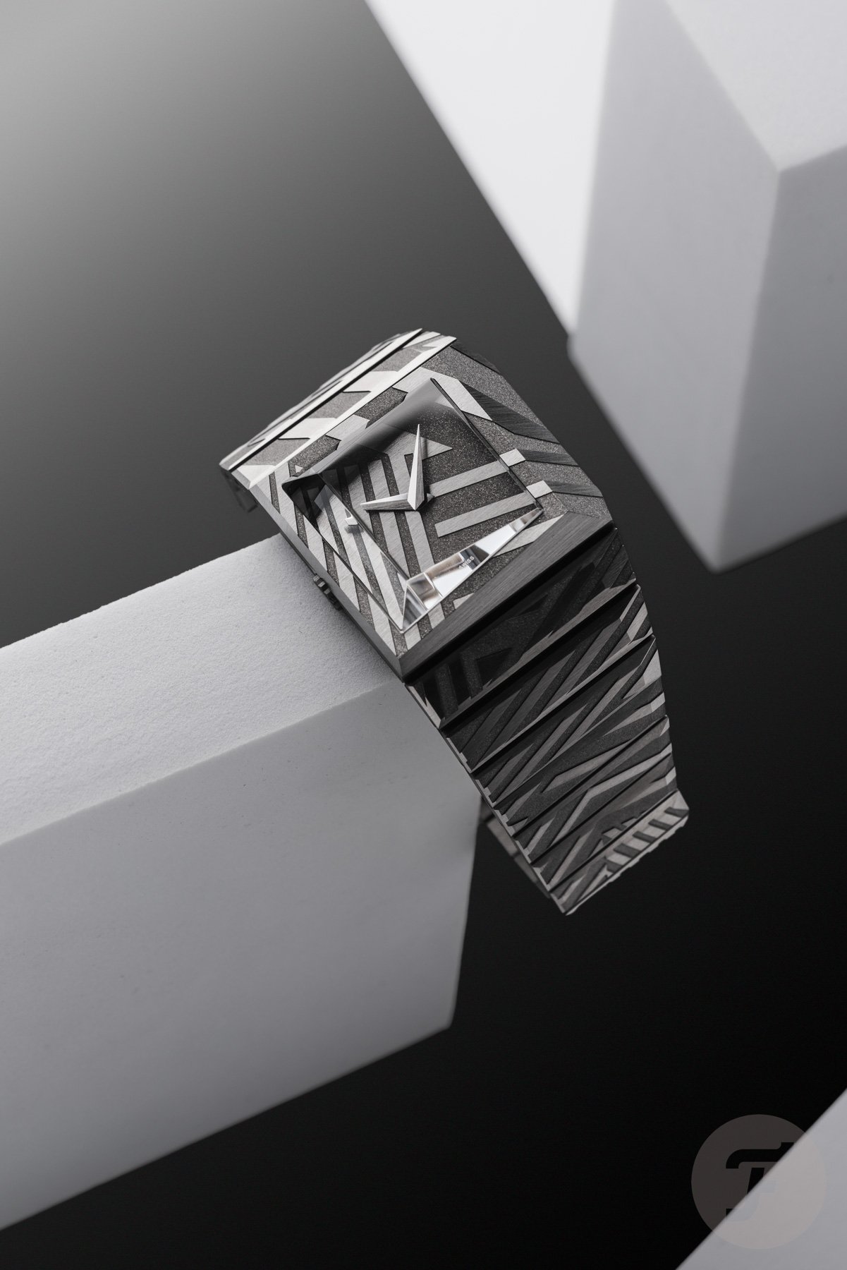 Toledano & Chan B/1 Dazzle hanging off of white block