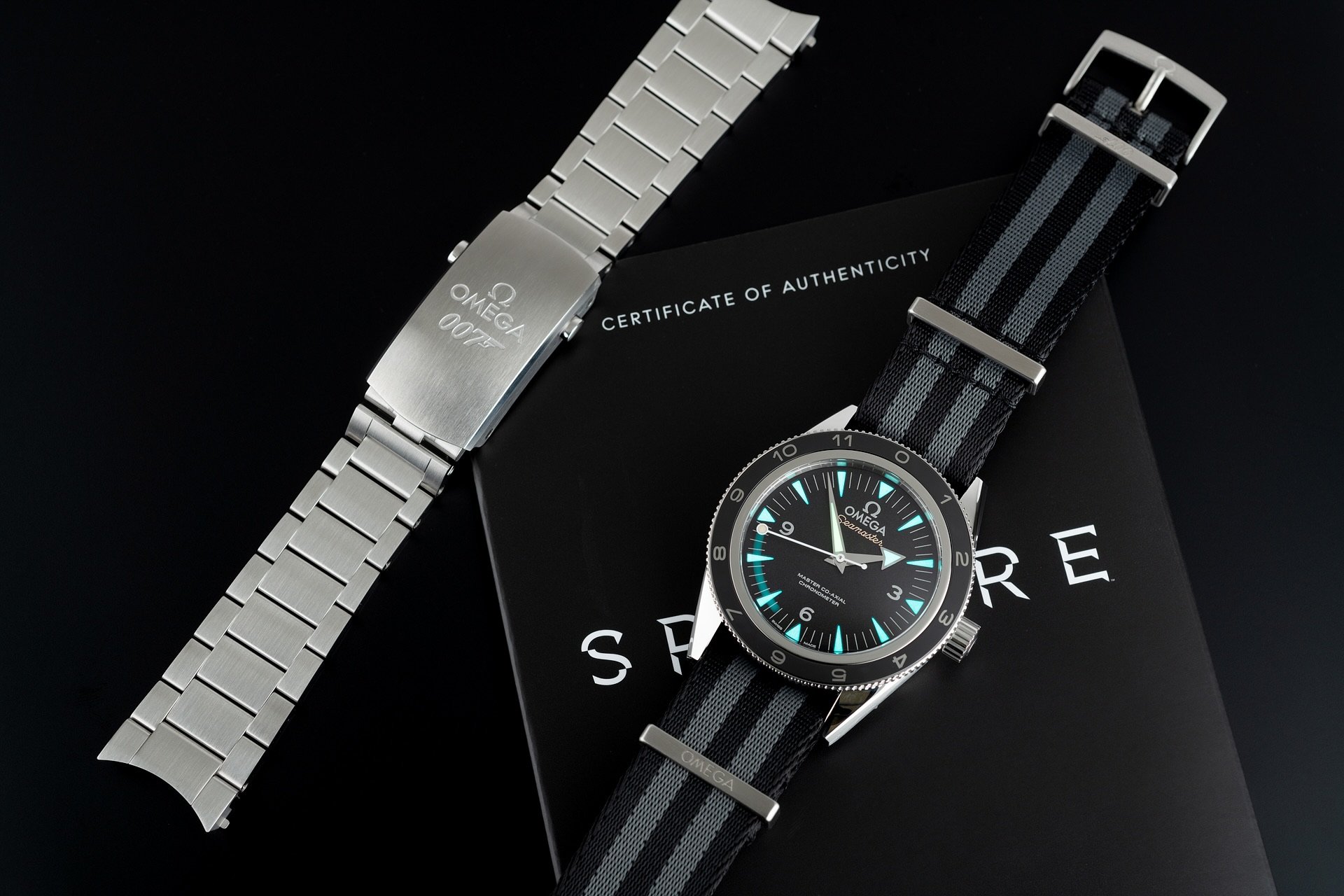 Bond watches — Omega Seamaster 300 Spectre ref. 233.32.41.21.01.001 next to bracelet, flat-lay