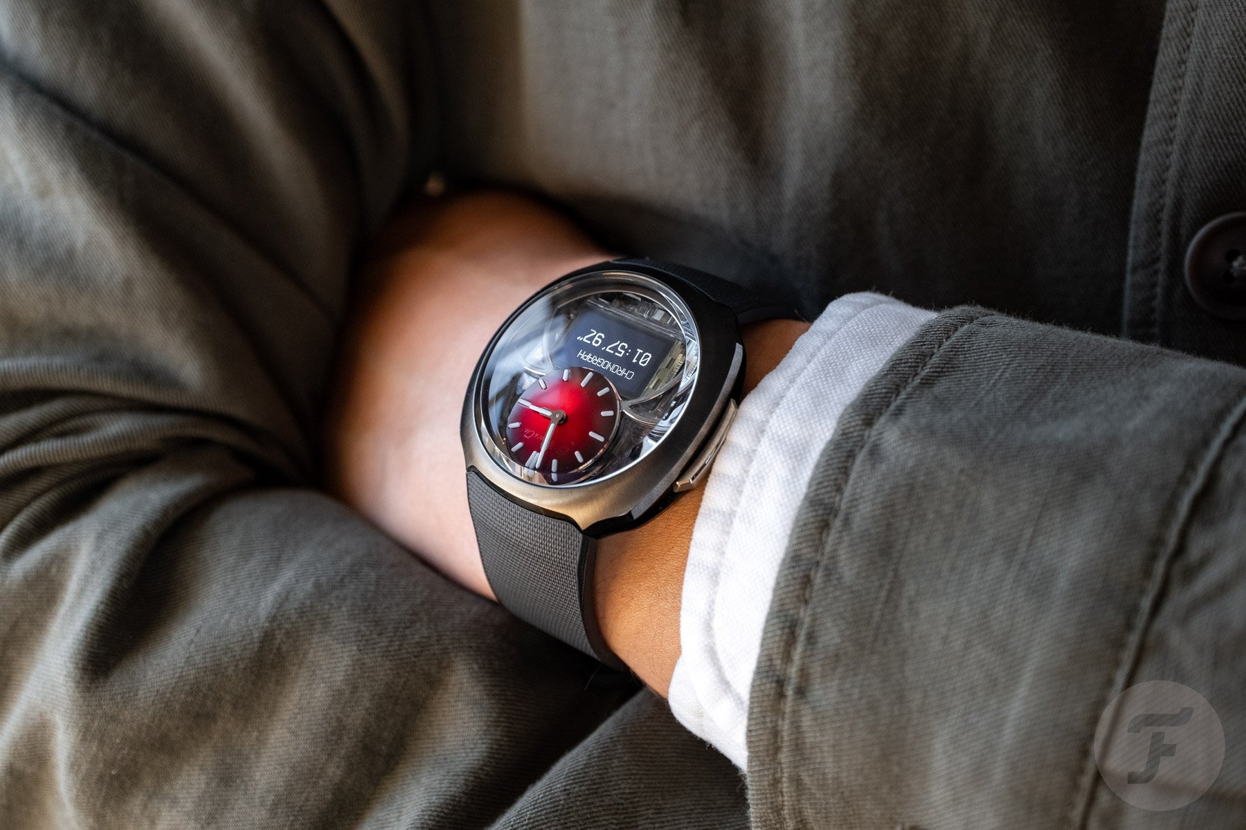red-dial H. Moser & Cie. Off-Grid on wrist, arms crossed