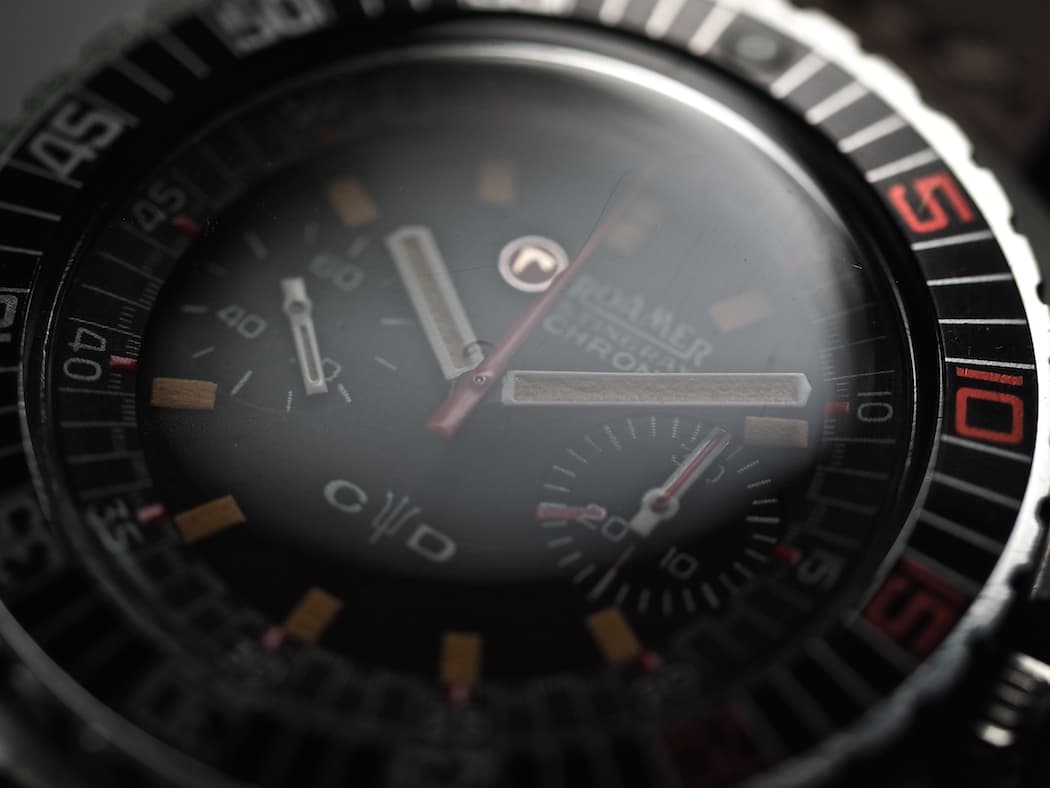 See the signed crystal with "r" logo on the Roamer Stingray Chrono Diver